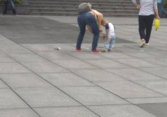 女子带着小孩当街大便后走人 留一地“黄金”